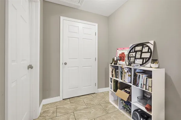 a view of a book shelf with a room in the background