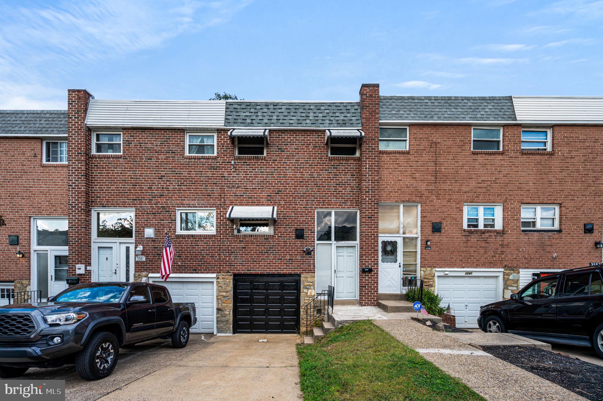 a car parked in front of a brick house
