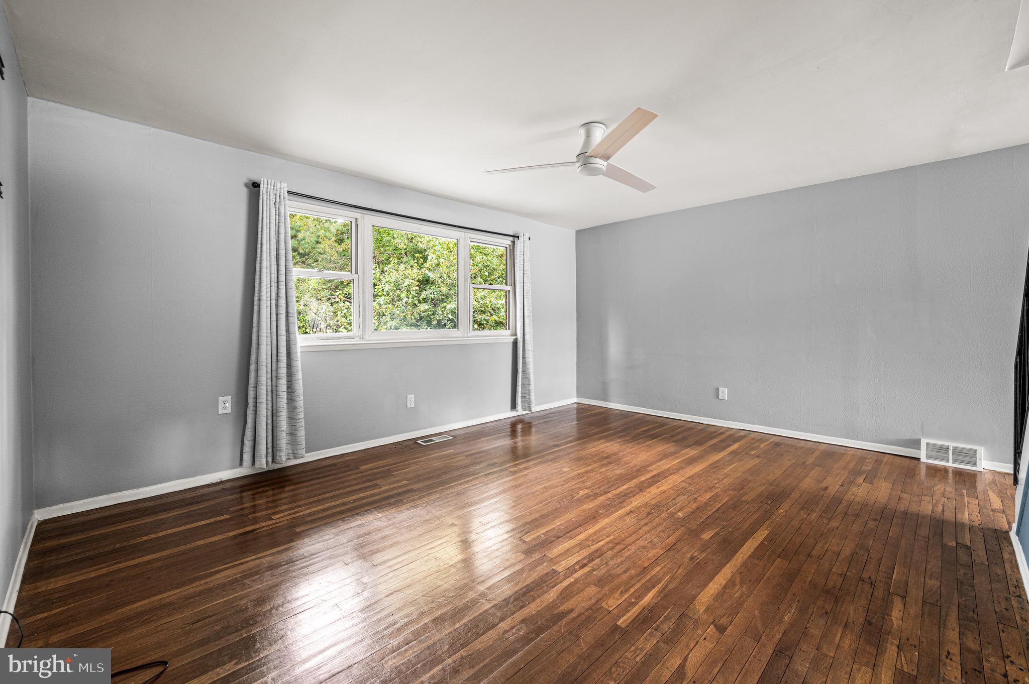 3583 Nottingham Lane Philadelphia, PA 19114 - Photo 6 of 23 an empty room with wooden floor fan and windows