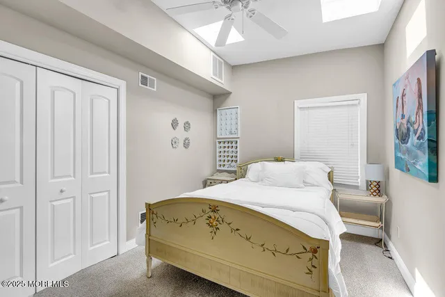 a bedroom with a bed and a mirror