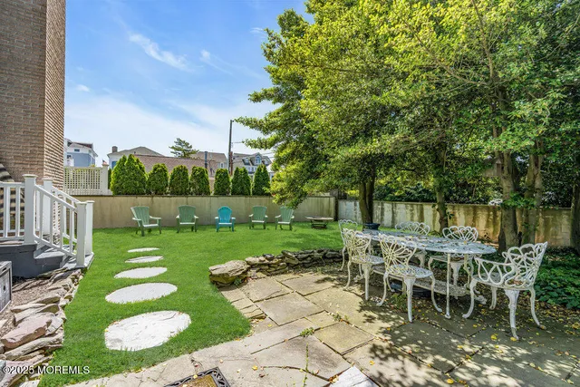 a view of a chairs and table in backyard