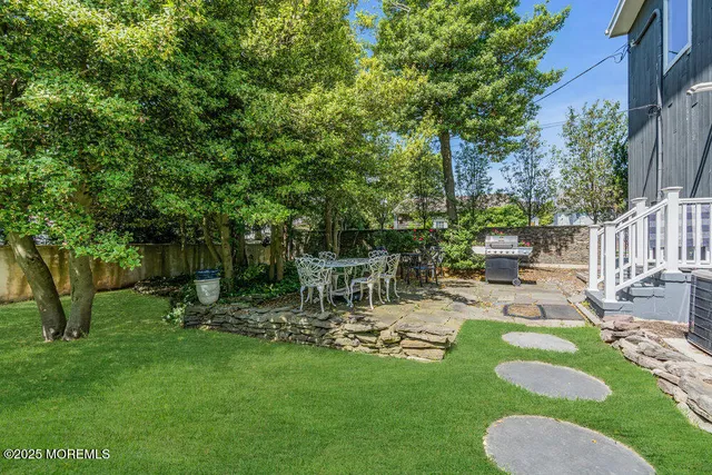 a view of backyard with a garden and outdoor seating