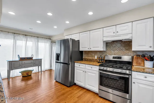 a kitchen with refrigerator and cabinets