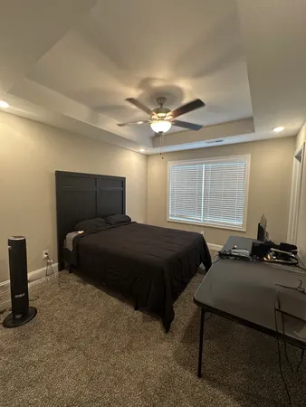 a bedroom with a bed and window