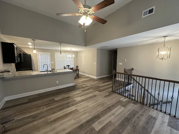 a view of a kitchen with a sink and cabinets