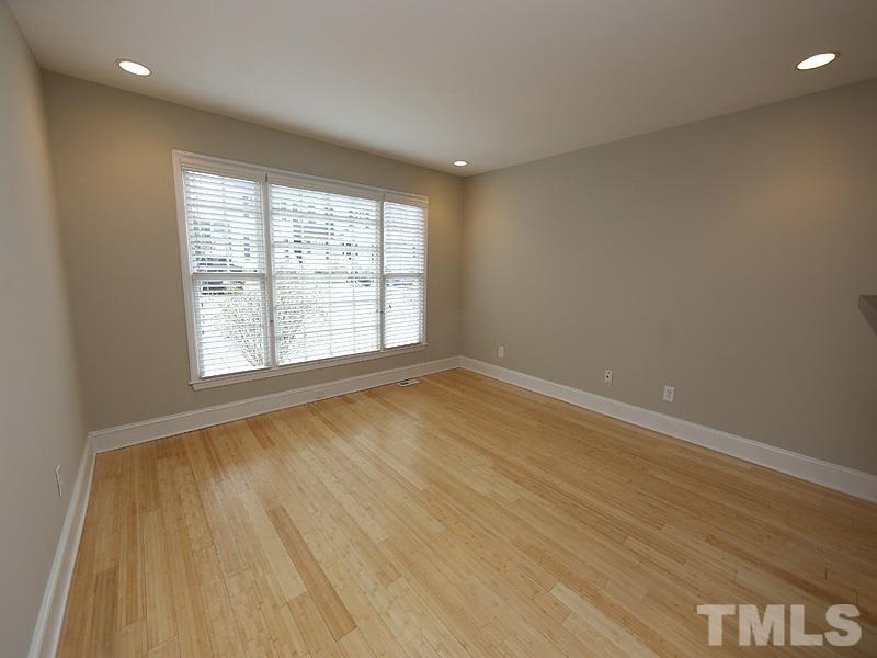 2554 Noble Road Raleigh, NC 27608 - Photo 2 of 11 an empty room with wooden floor and windows