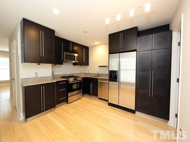2554 Noble Road Raleigh, NC 27608 - Photo 5 of 11 a kitchen with a refrigerator sink and microwave