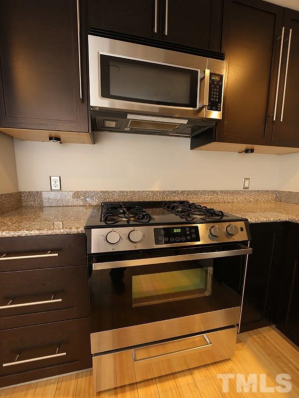 2554 Noble Road Raleigh, NC 27608 - Photo 6 of 11 a stove top oven sitting inside of a kitchen