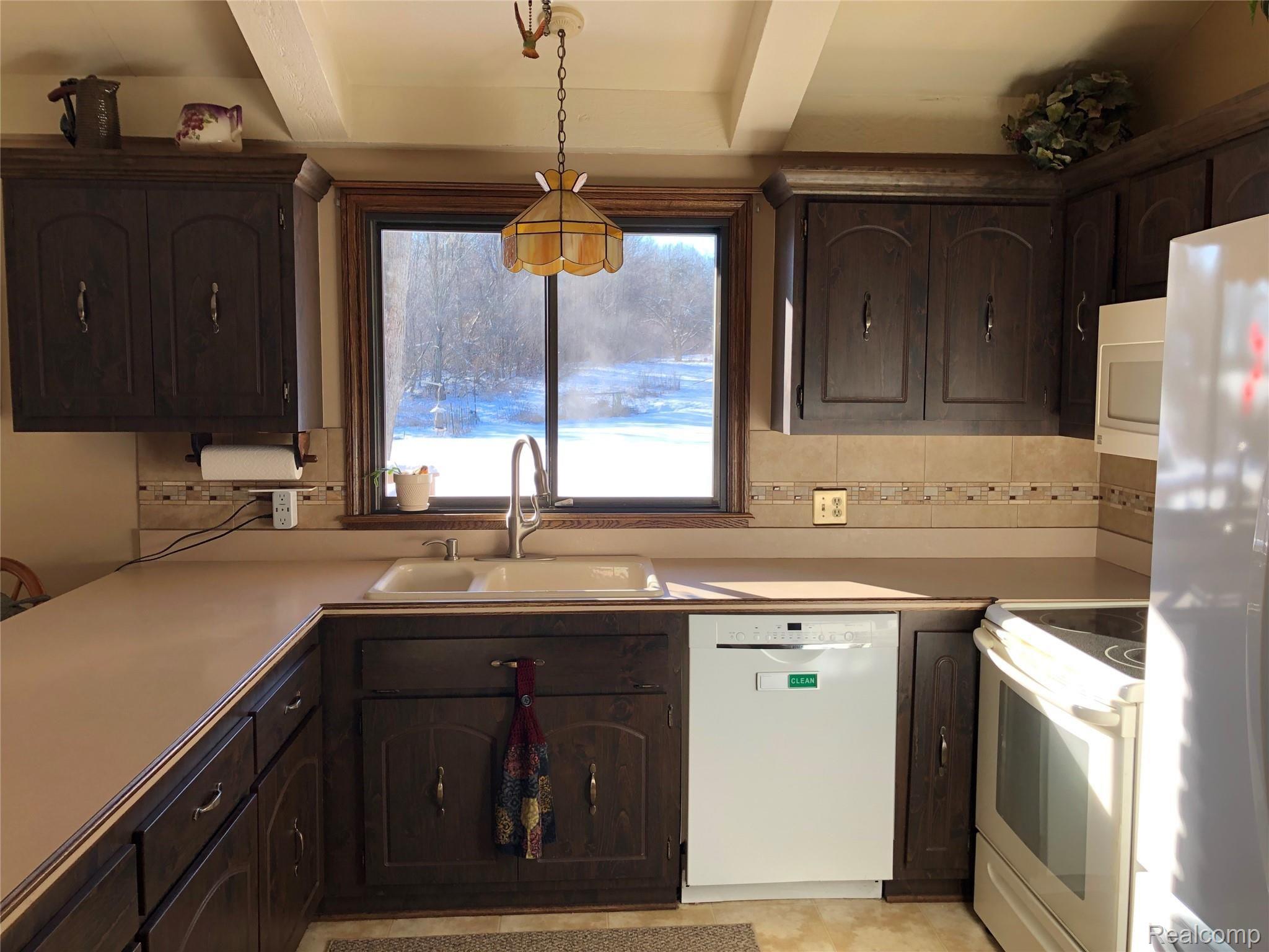 5208 Casey Road Dryden, MI 48428 - Photo 17 of 52 Kitchen has lots of counter space & pretty tile detail on backsplash
