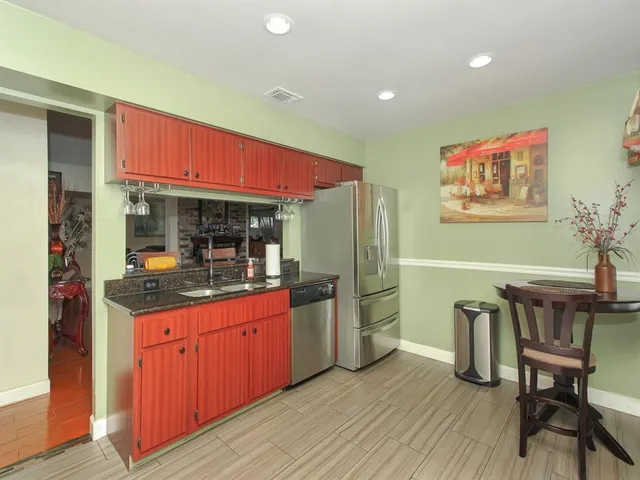 a kitchen with stainless steel appliances granite countertop a stove and refrigerator