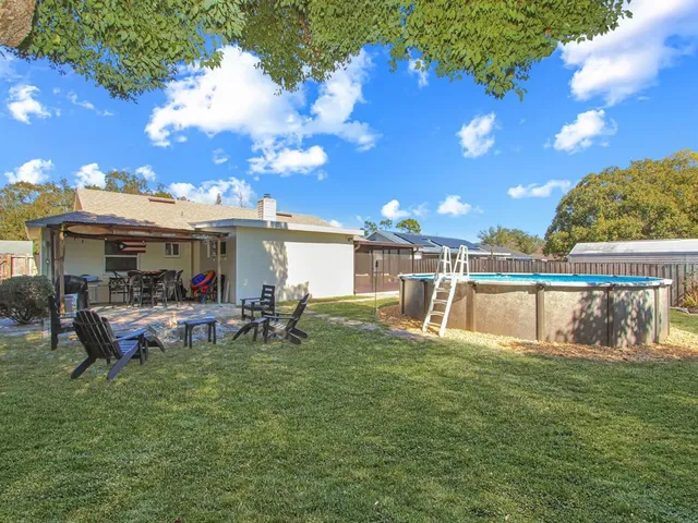 a view of a house with a backyard porch and sitting area