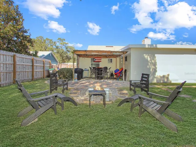 a view of a chair and table in backyard