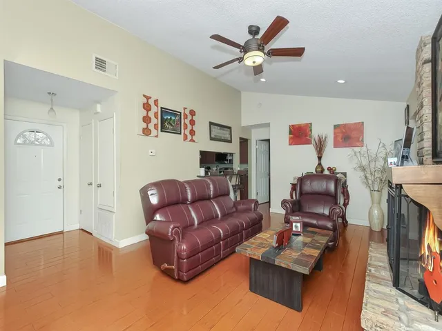 a living room with furniture and a view of kitchen