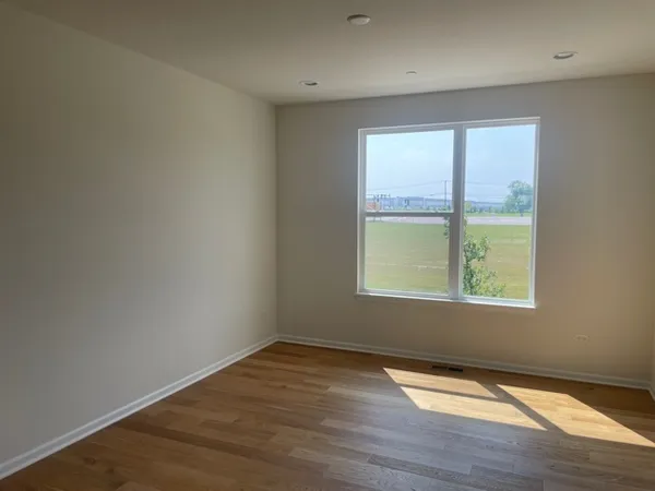 a large white kitchen with a large window