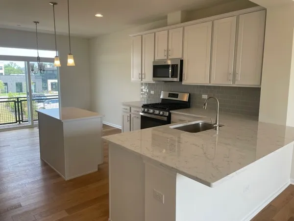 a kitchen with a sink cabinets and window