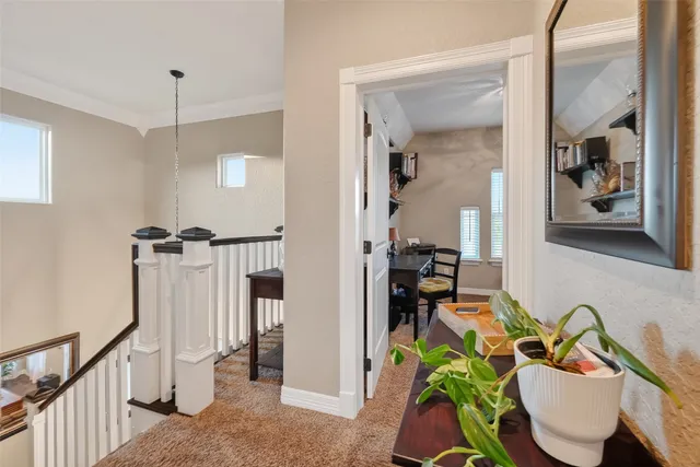 a view of a dining room with furniture a rug and wooden floor