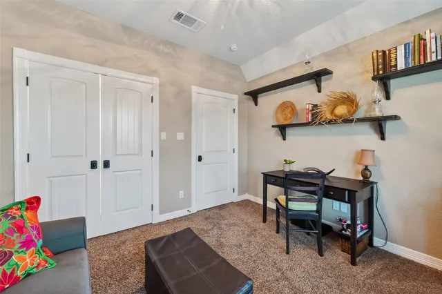 a bedroom with furniture and a book shelf