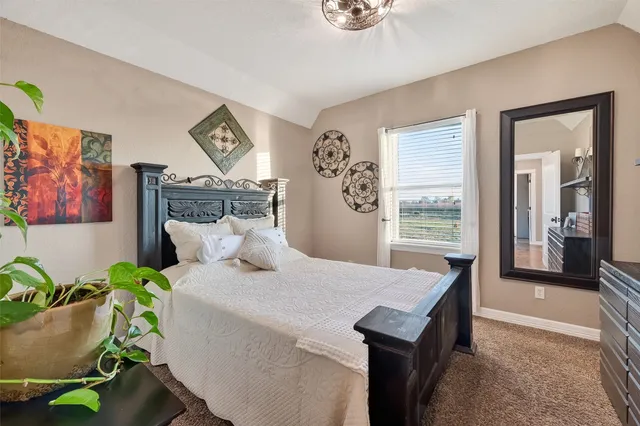 a bedroom with a bed and a table in it