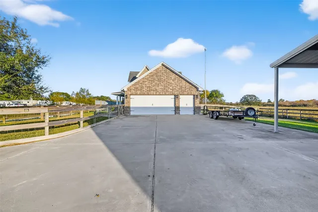 a view of a house with a yard and sitting area