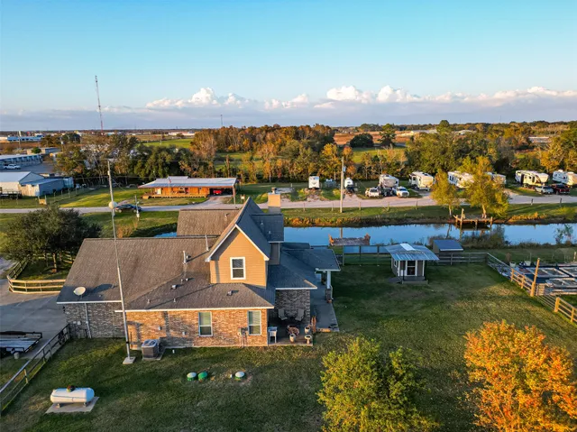 an aerial view of a house with swimming pool lake view and mountain view