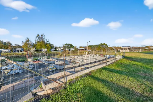 a view of a lake with lawn chairs