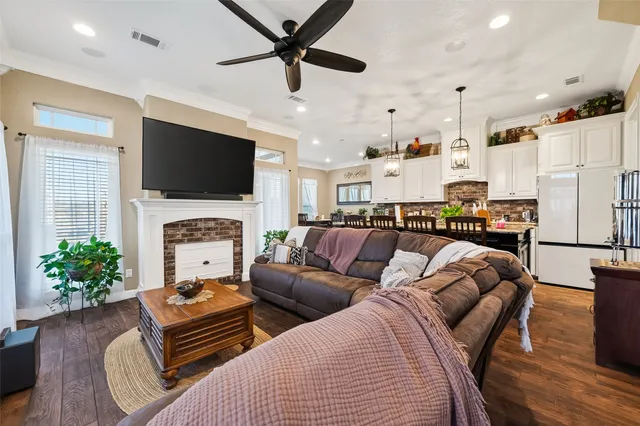 a living room with furniture a fireplace and a flat screen tv