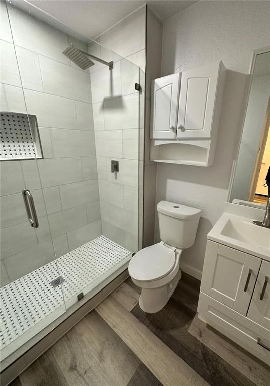 2400 Jupiter Road, Unit 6 Plano, TX 75074 - Photo 7 of 8 a bathroom with a toilet sink a mirror and vanity