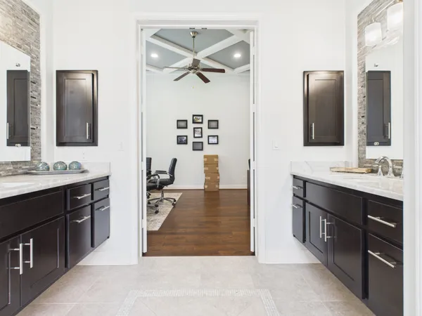 a spacious bathroom with a double vanity sink a mirror and a shower