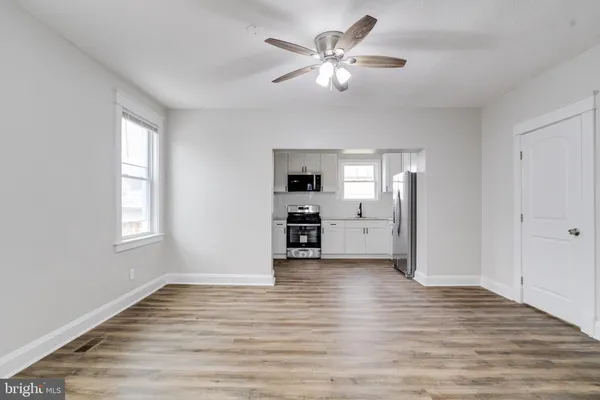 a view of kitchen with microwave a stove top oven and cabinets