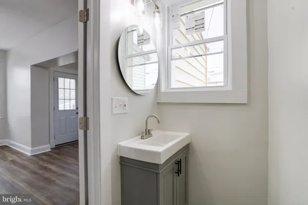 a view of a hallway with a white walls and stairs