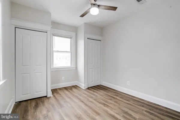 a view of a room with wooden floor