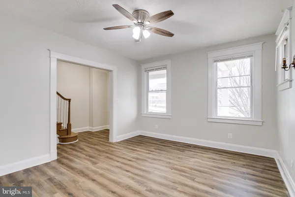a view of wooden floor and windows in a room
