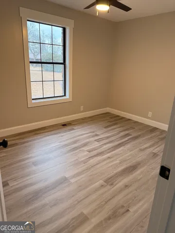 wooden floor in an empty room with a window