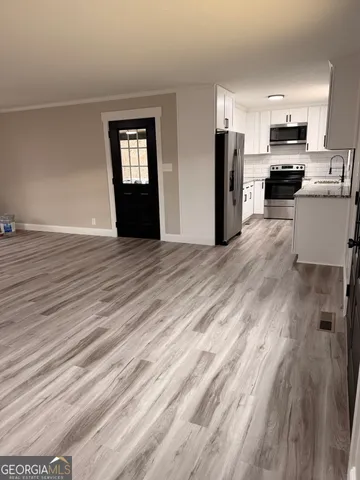 a view of a kitchen with microwave and cabinets