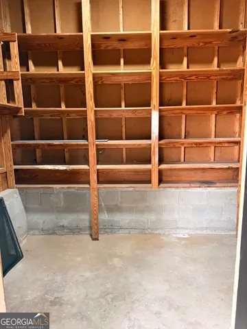a view of an empty room with empty shelves