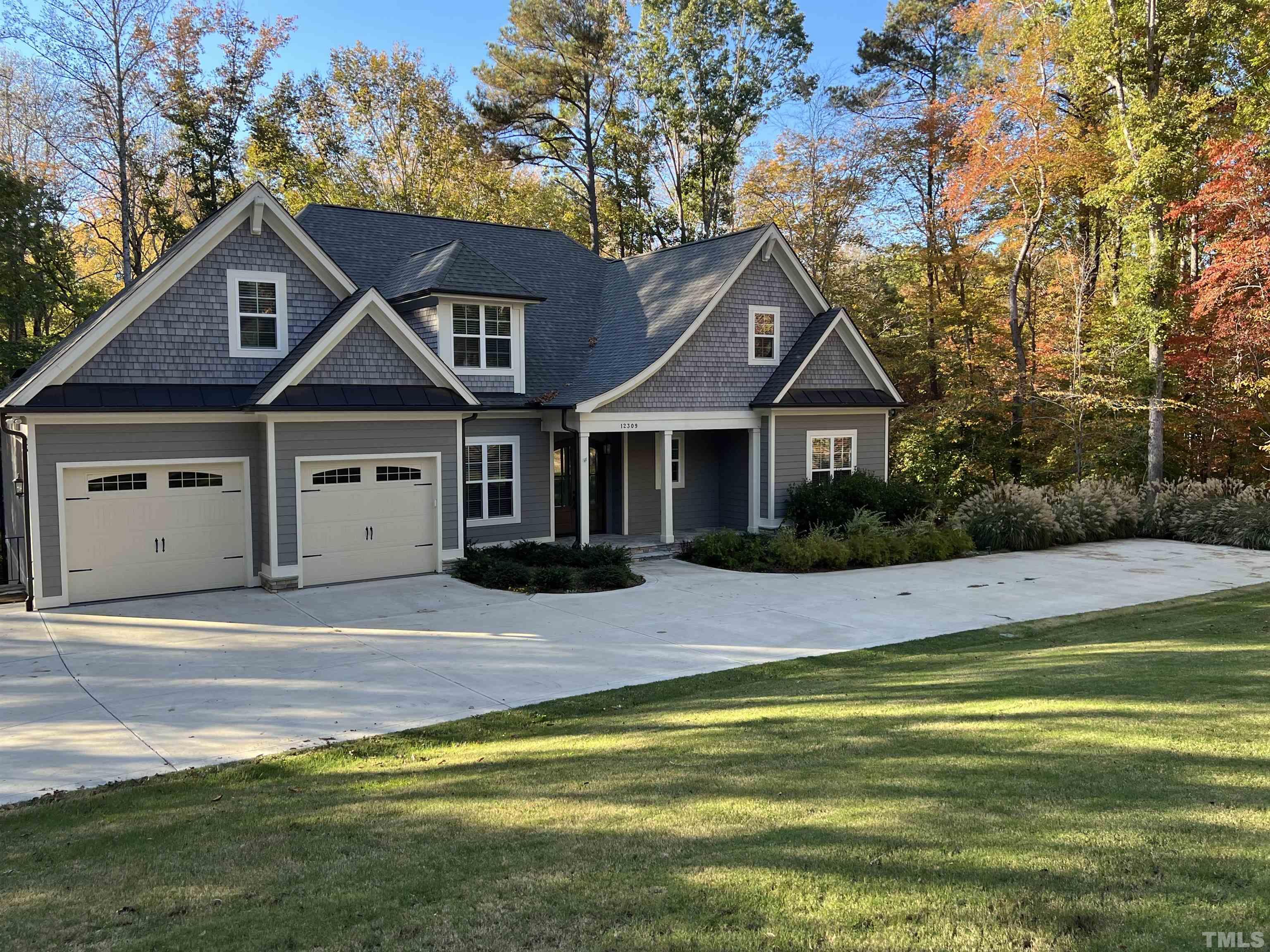 12309 Creedmoor Road Raleigh, NC 27613 - Photo 1 of 38 a front view of a house with a garden and yard
