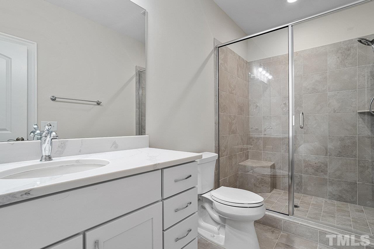 12309 Creedmoor Road Raleigh, NC 27613 - Photo 33 of 38 a bathroom with a sink toilet and shower