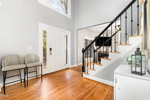 a view of entryway and hall with wooden floor