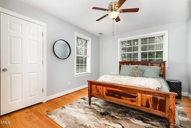 a bedroom with a bed and wooden floor