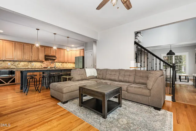 a living room with furniture and kitchen view