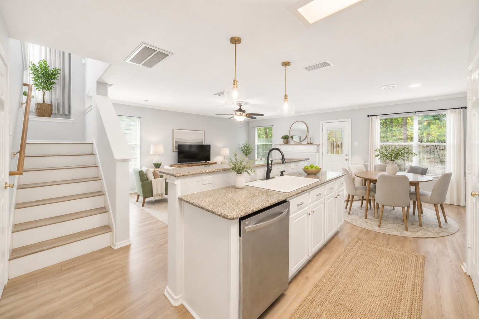 38 Musgrove Place Spring, TX 77382 - Photo 3 of 36 Open-concept kitchen shines with granite island, white cabinetry, pendant lights, and sunlit breakfast nook.