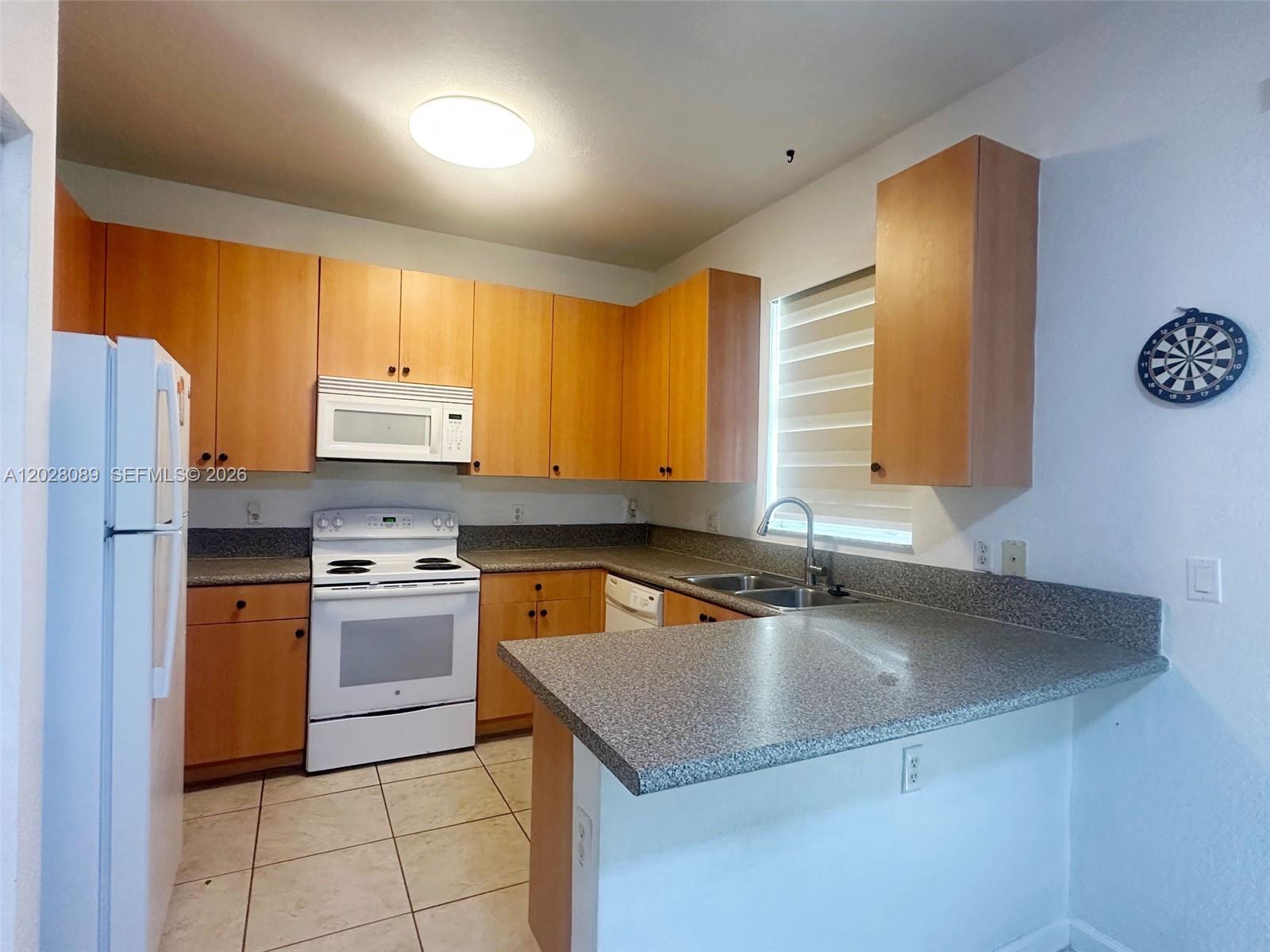 662 Northeast 21st Terrace Homestead, FL 33033 - Photo 28 of 34 a kitchen with stainless steel appliances granite countertop a sink stove and refrigerator