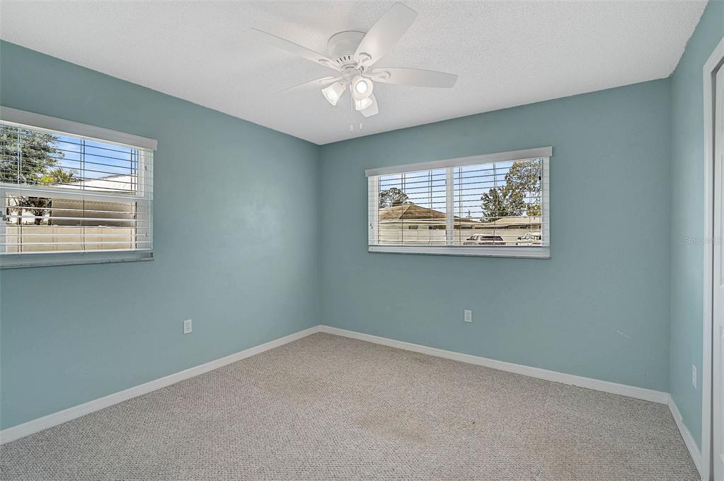 602 Park Circle Bradenton, FL 34207 - Photo 19 of 34 an empty room with windows and fan