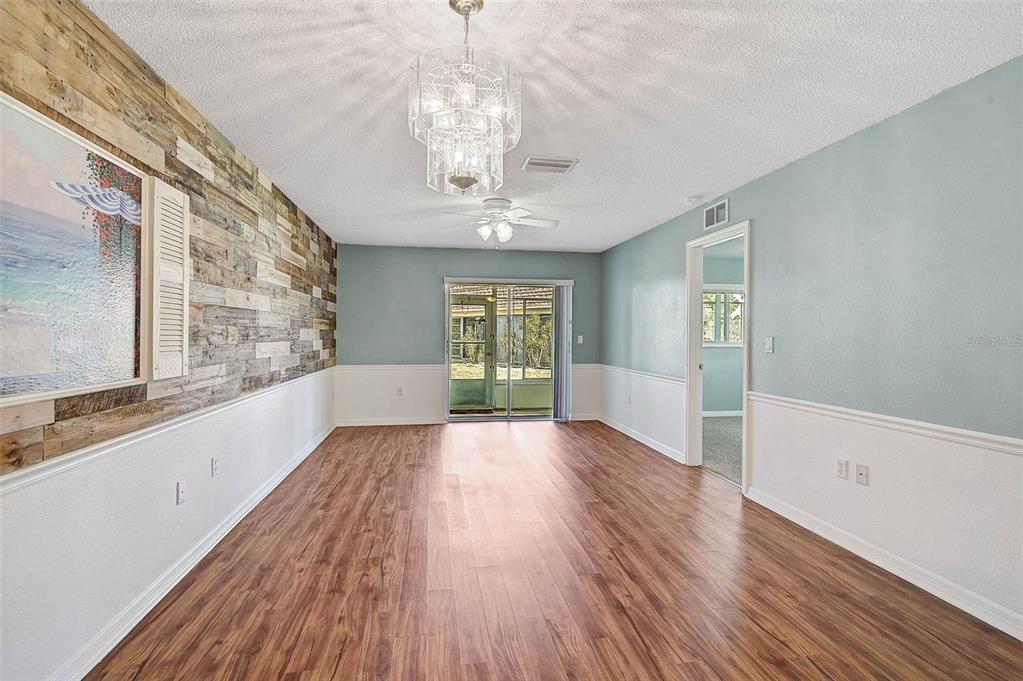602 Park Circle Bradenton, FL 34207 - Photo 5 of 34 a view of an empty room with wooden floor and a window