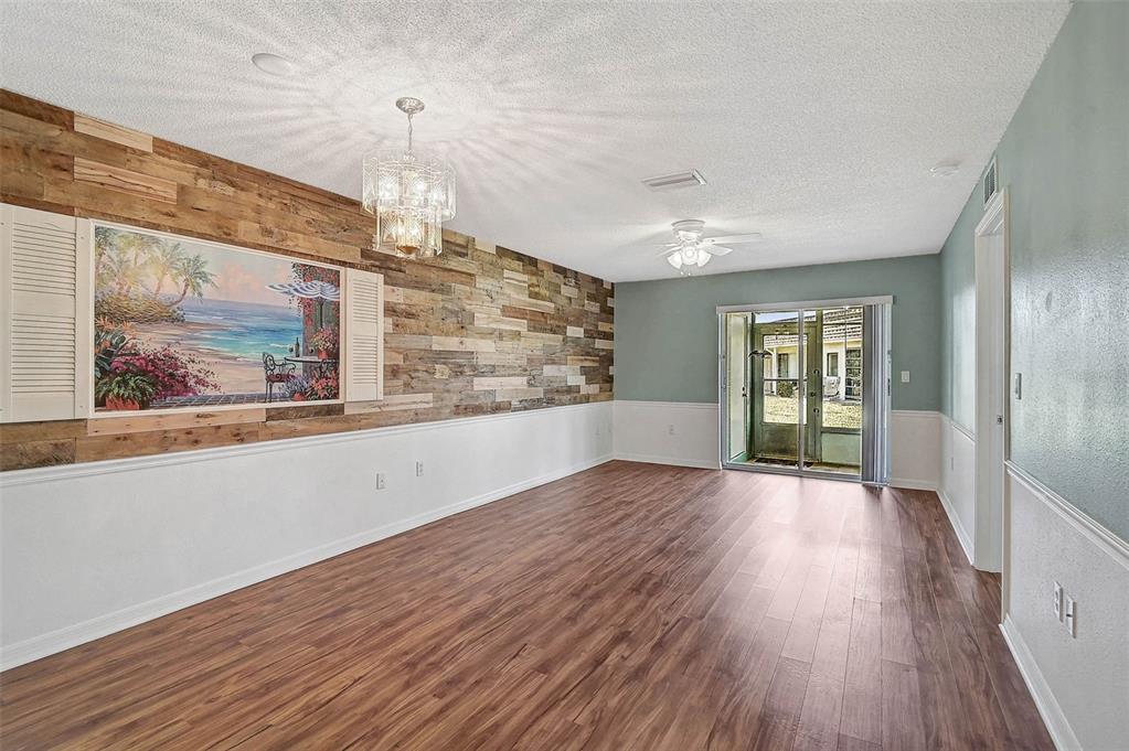 602 Park Circle Bradenton, FL 34207 - Photo 6 of 34 a view of an empty room with wooden floor and a window