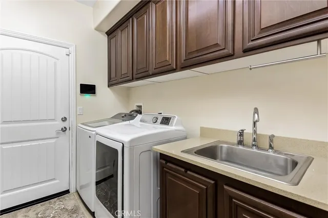 a utility room with sink dryer and washer