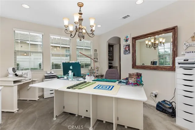 a view of a dining room with furniture a chandelier and wooden floor