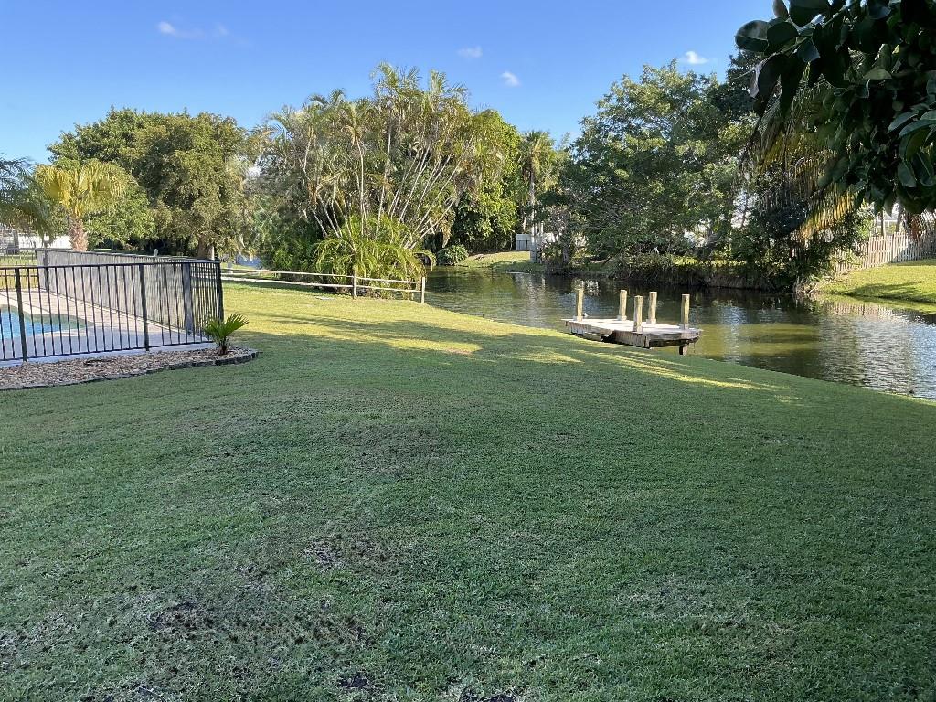9774 Lancaster Place Boca Raton, FL 33434 - Photo 4 of 13 a view of yard with green space and trees in the background