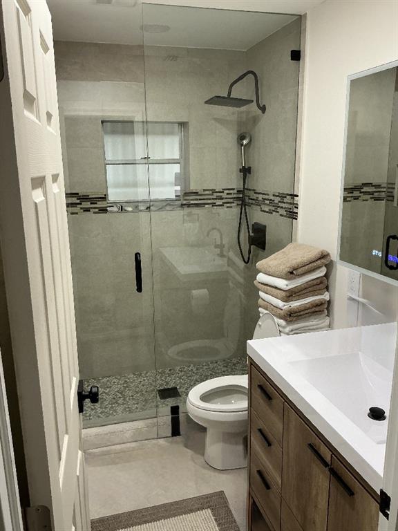 9774 Lancaster Place Boca Raton, FL 33434 - Photo 7 of 13 a bathroom with a sink a toilet and shower