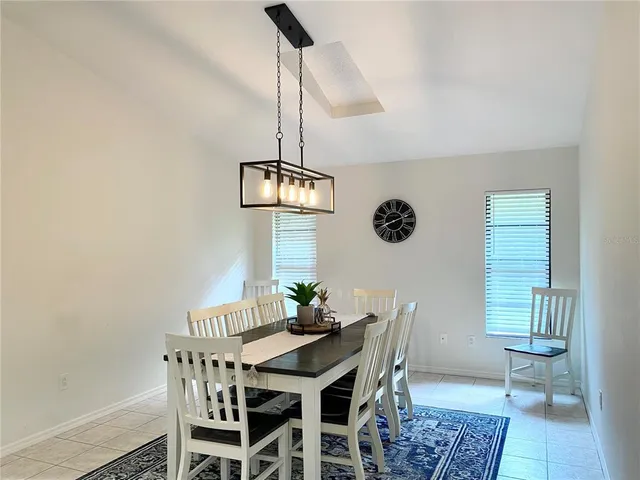 a view of a dining room with furniture and chandelier